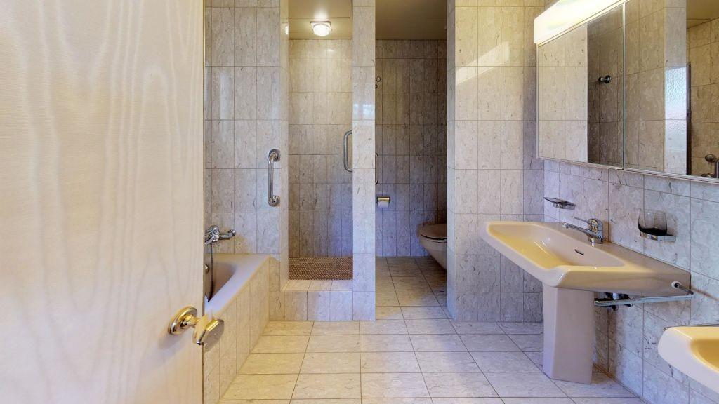 Badezimmer mit Marmoroptik und Dusche